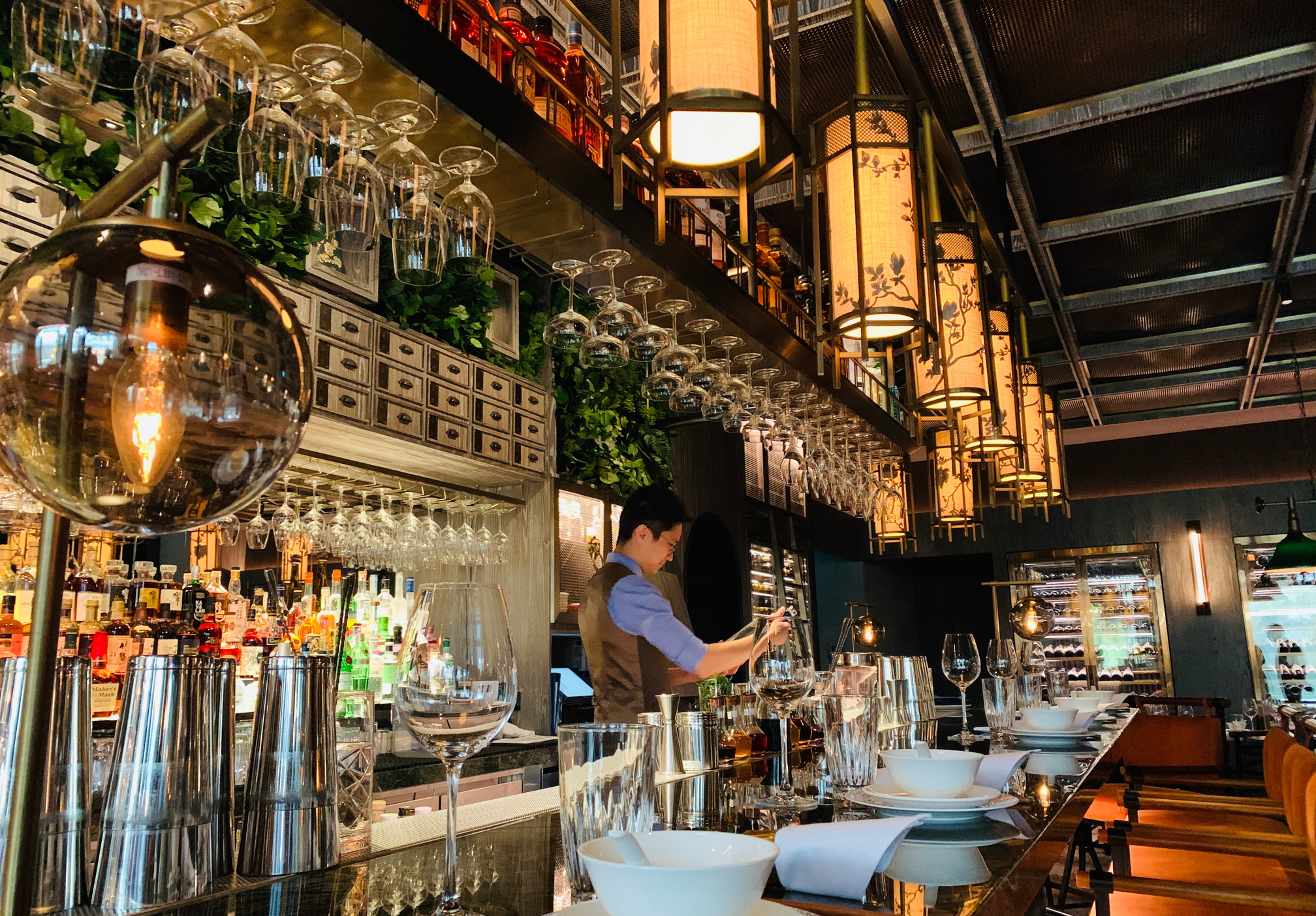 Bartender working at bar counter in oriental restaurant